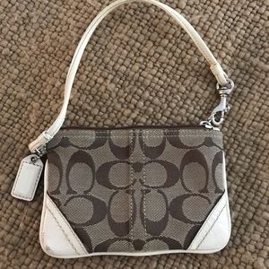 Coach wristlet. Some bruising in corner.